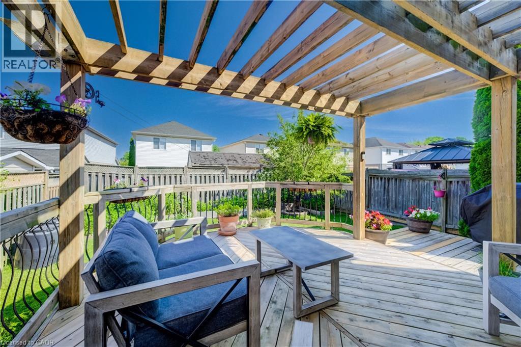 Expansive wood deck with an overhead pergola, featuring wood-plank flooring and a perimeter wood railing - 496 Langlaw Drive, Cambridge, ON - Outdoor With Deck Patio Veranda With Exterior