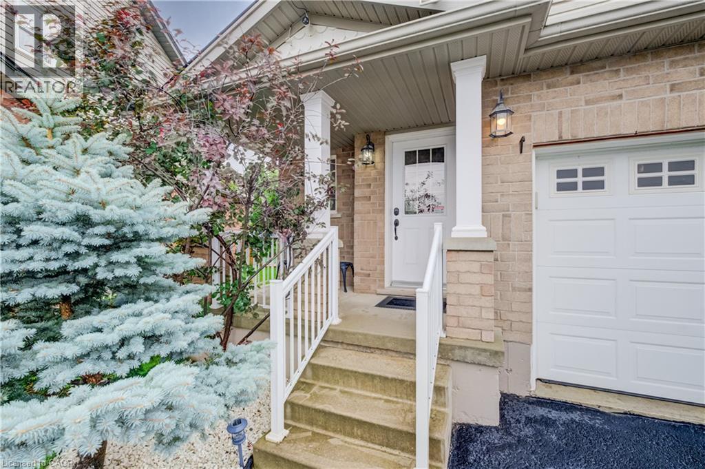 Brick exterior with a covered porch entry - 521 Snowdrop Court, Kitchener, ON - Outdoor