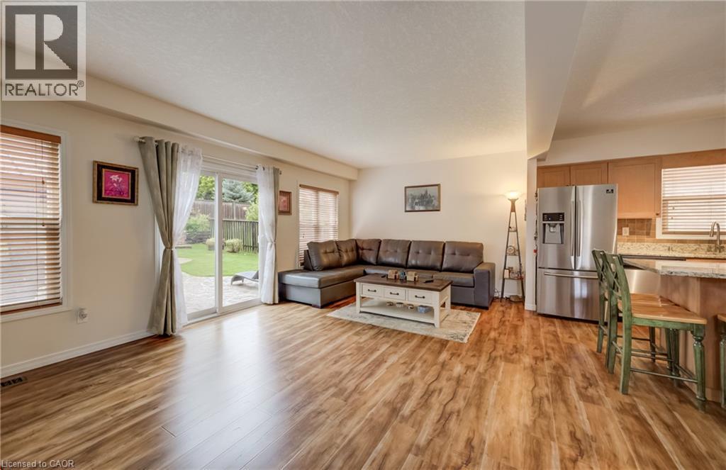 Open-concept living space with wood-finish flooring - 521 Snowdrop Court, Kitchener, ON - Indoor