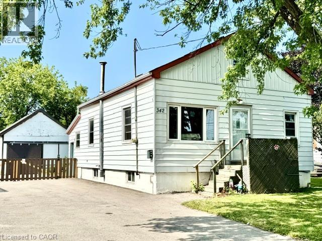 White siding exterior with a red trim roofline - 342 Barton Street, Hamilton, ON - Outdoor
