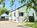 White siding exterior with a red trim roofline - 342 Barton Street, Hamilton, ON  - Outdoor 