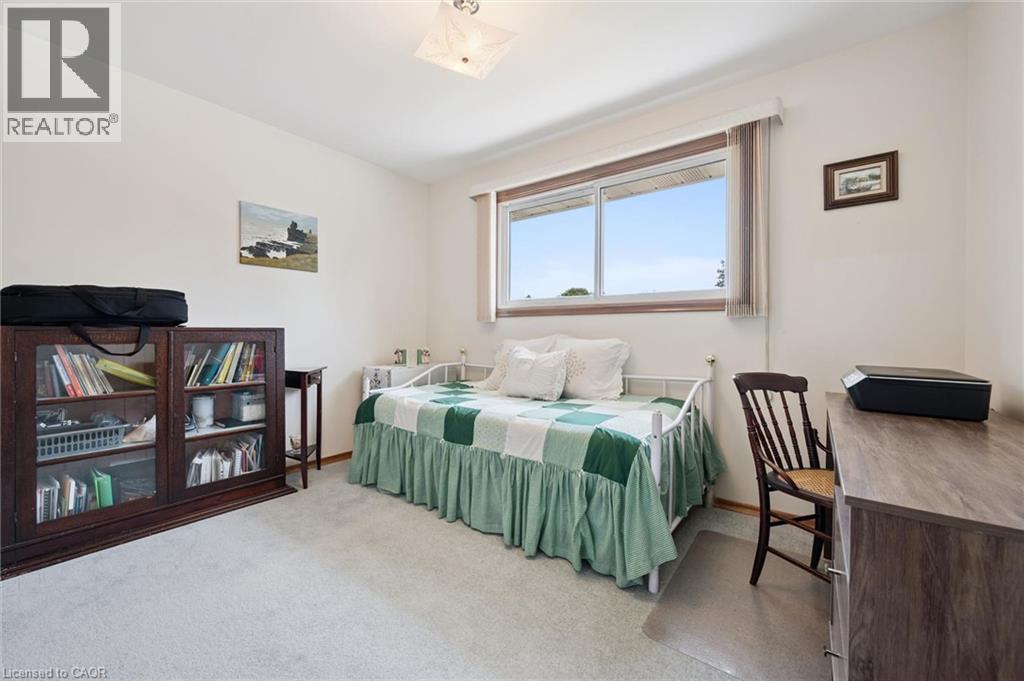 White wall interior with light gray carpeting, featuring a large window - 18 Strathcona Crescent, Kitchener, ON - Indoor Photo Showing Bedroom