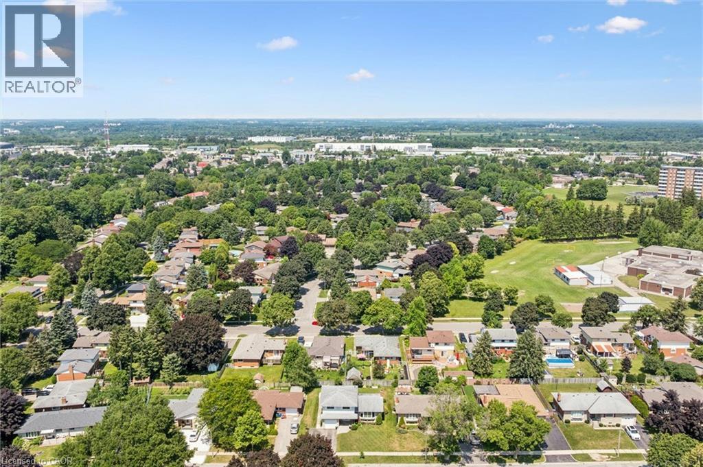Aerial view showcasing a tree-lined residential neighborhood with mature landscaping, spacious lot sizes, and low-density suburban character - 18 Strathcona Crescent, Kitchener, ON - Outdoor With View