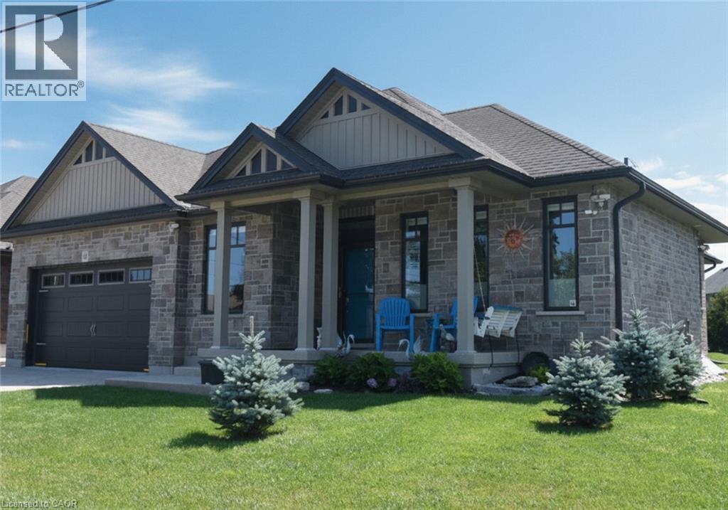 Contemporary stone exterior with architectural gable detailing and multiple roof peaks - 10 Craddock Boulevard, Jarvis, ON - Outdoor With Facade