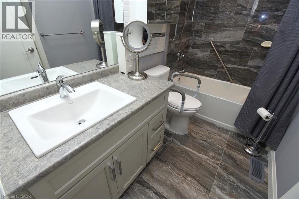 Bathroom featuring a vanity with a white rectangular undermount sink and a light gray countertop - 10 Craddock Boulevard, Jarvis, ON - Indoor Photo Showing Bathroom