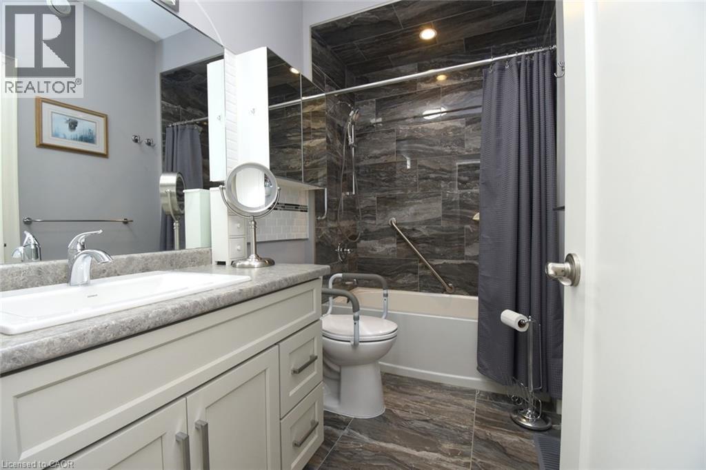 Spa-inspired bathroom featuring a floating vanity with stone countertop, chrome vessel sink, and polished chrome faucet - 10 Craddock Boulevard, Jarvis, ON - Indoor Photo Showing Bathroom