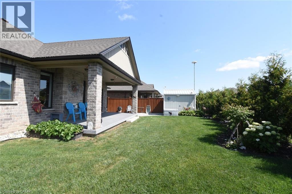 Contemporary brick residence with a covered front porch, featuring a pitched roof and gable detailing - 10 Craddock Boulevard, Jarvis, ON - Outdoor