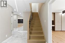 Light wood staircase with wrought iron balusters - 