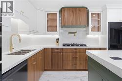 Modern kitchen featuring white and wood-finish cabinetry - 
