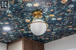 Ceiling featuring a floral pattern, a brass and frosted glass globe light fixture, and a recessed ceiling light - 