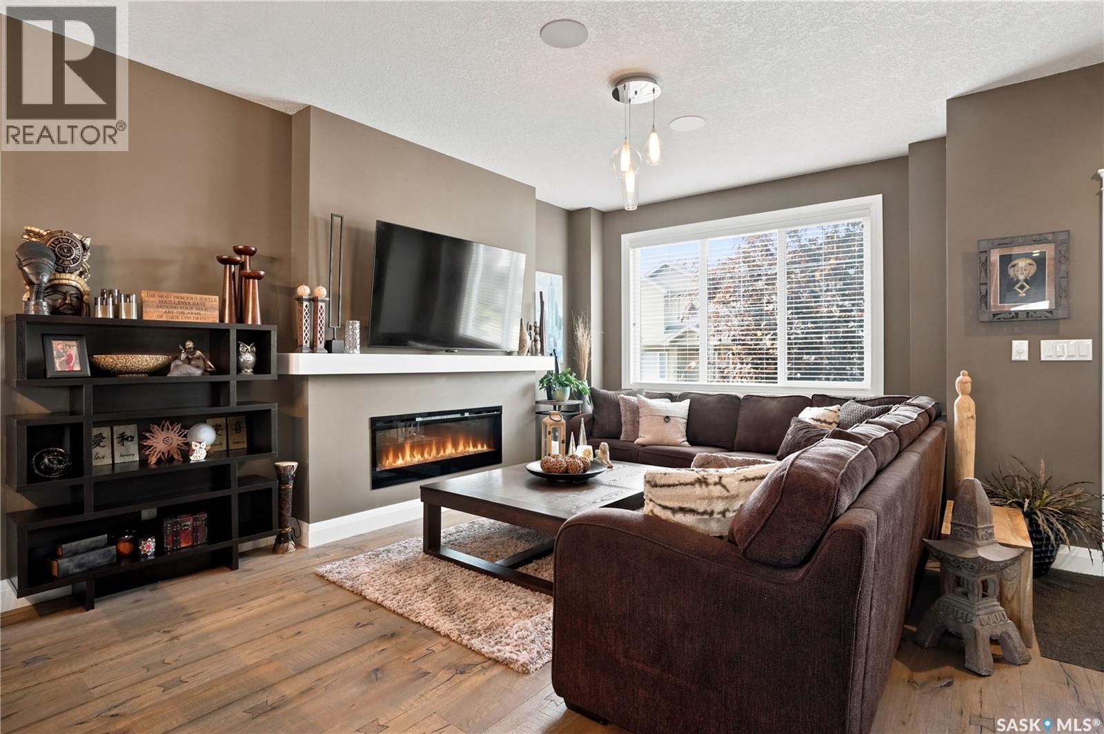 5413 Green Silverberry Drive E, Regina, SK - Indoor Photo Showing Living Room With Fireplace