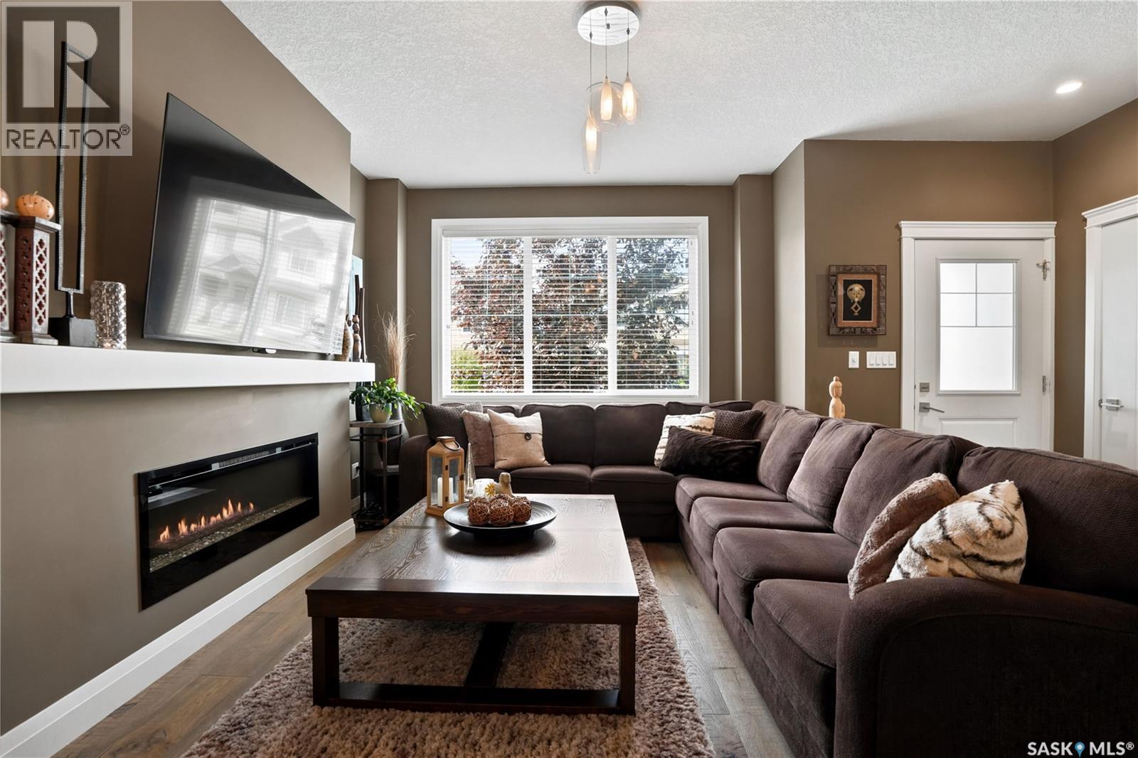 5413 Green Silverberry Drive E, Regina, SK - Indoor Photo Showing Living Room With Fireplace