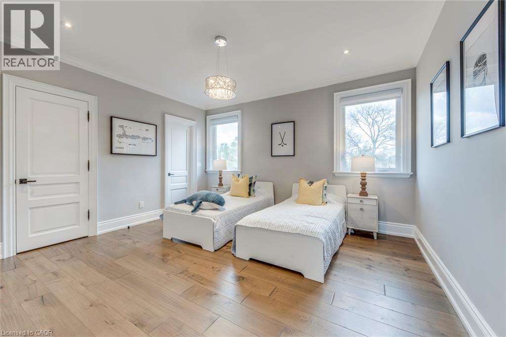Bedroom featuring wide plank wood-finish flooring, light grey wall paint, and white trim - 436 Willis Drive, Oakville, ON - Indoor Photo Showing Bedroom