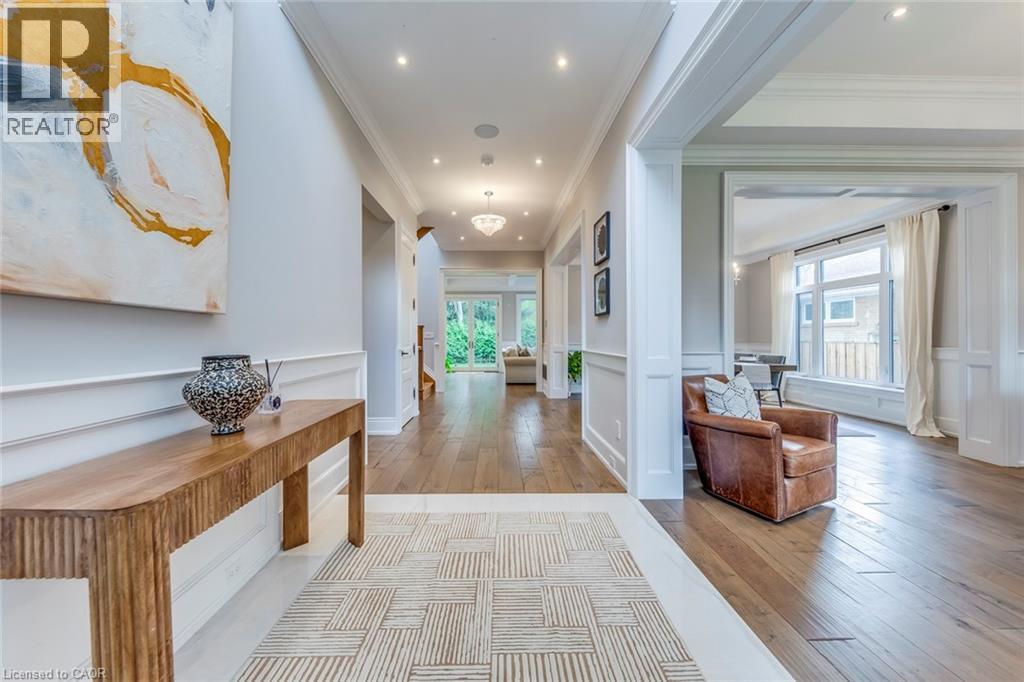 Spacious entryway featuring light wood-finish flooring, recessed lighting, crown molding, and wainscoting - 436 Willis Drive, Oakville, ON - Indoor Photo Showing Other Room