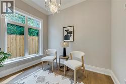 Hardwood-finish flooring, crown molding, and an elegant crystal chandelier - 