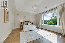 Tray ceiling with recessed lighting and a central chandelier - 