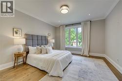Hardwood flooring, crown molding, recessed lighting, double-paned window, and a drum-style ceiling light fixture - 