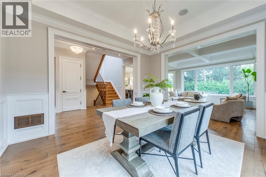 Dining area featuring a decorative chandelier and wood-finish flooring - 436 Willis Drive, Oakville, ON - Indoor Photo Showing Dining Room