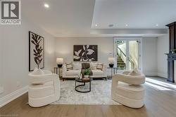 Wood-finish flooring, recessed lighting, double French doors, built-in fireplace, and a drop ceiling with integrated lighting - 