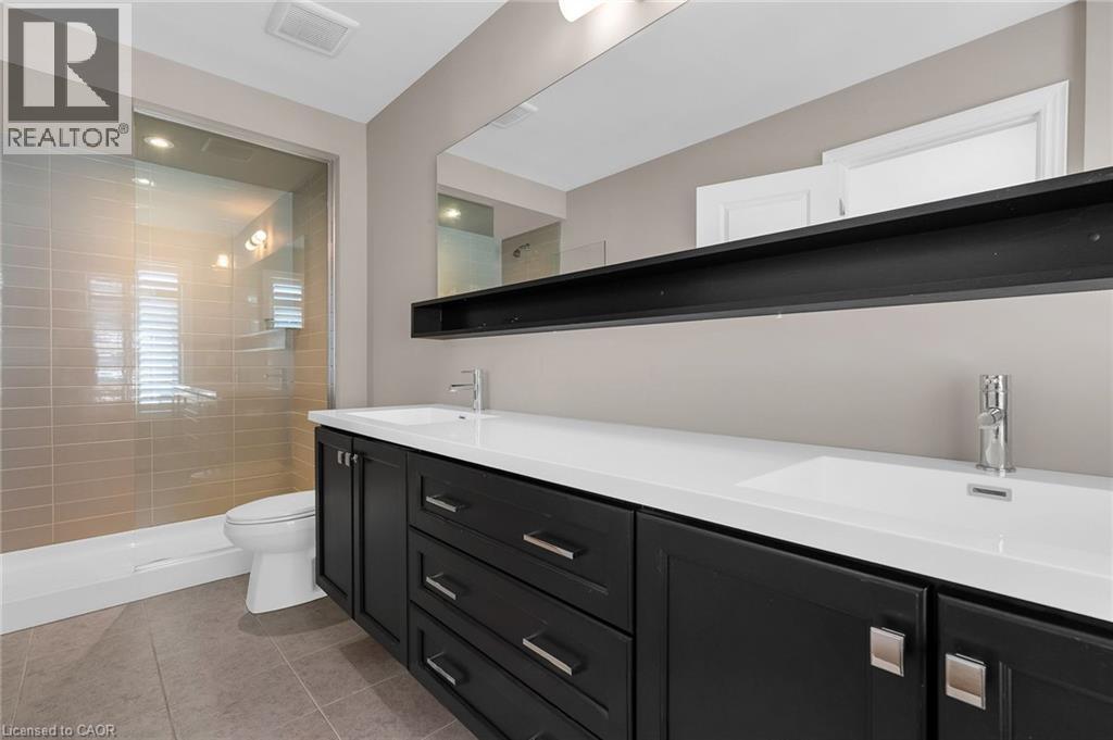 Double vanity with integrated sinks and dark wood-finish cabinetry - 2 Waterview Lane, Grimsby, ON - Indoor Photo Showing Bathroom