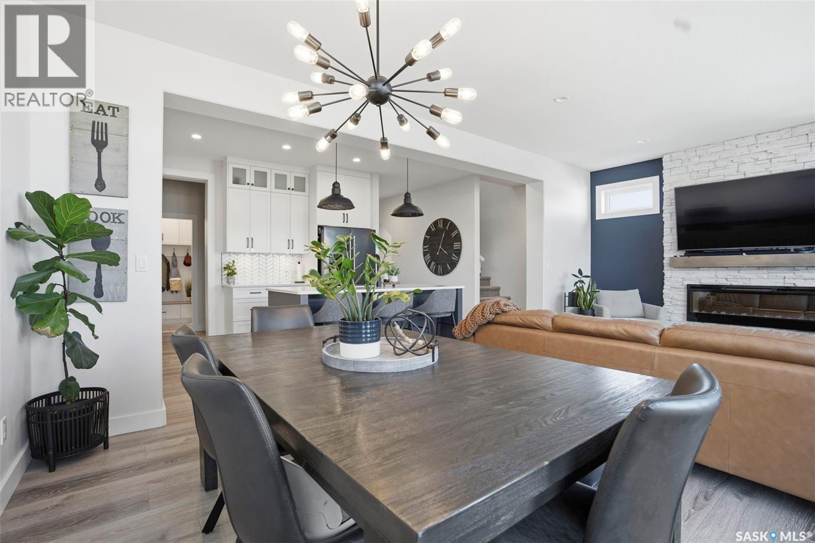 250 Skopik Crescent, Saskatoon, SK - Indoor Photo Showing Dining Room With Fireplace