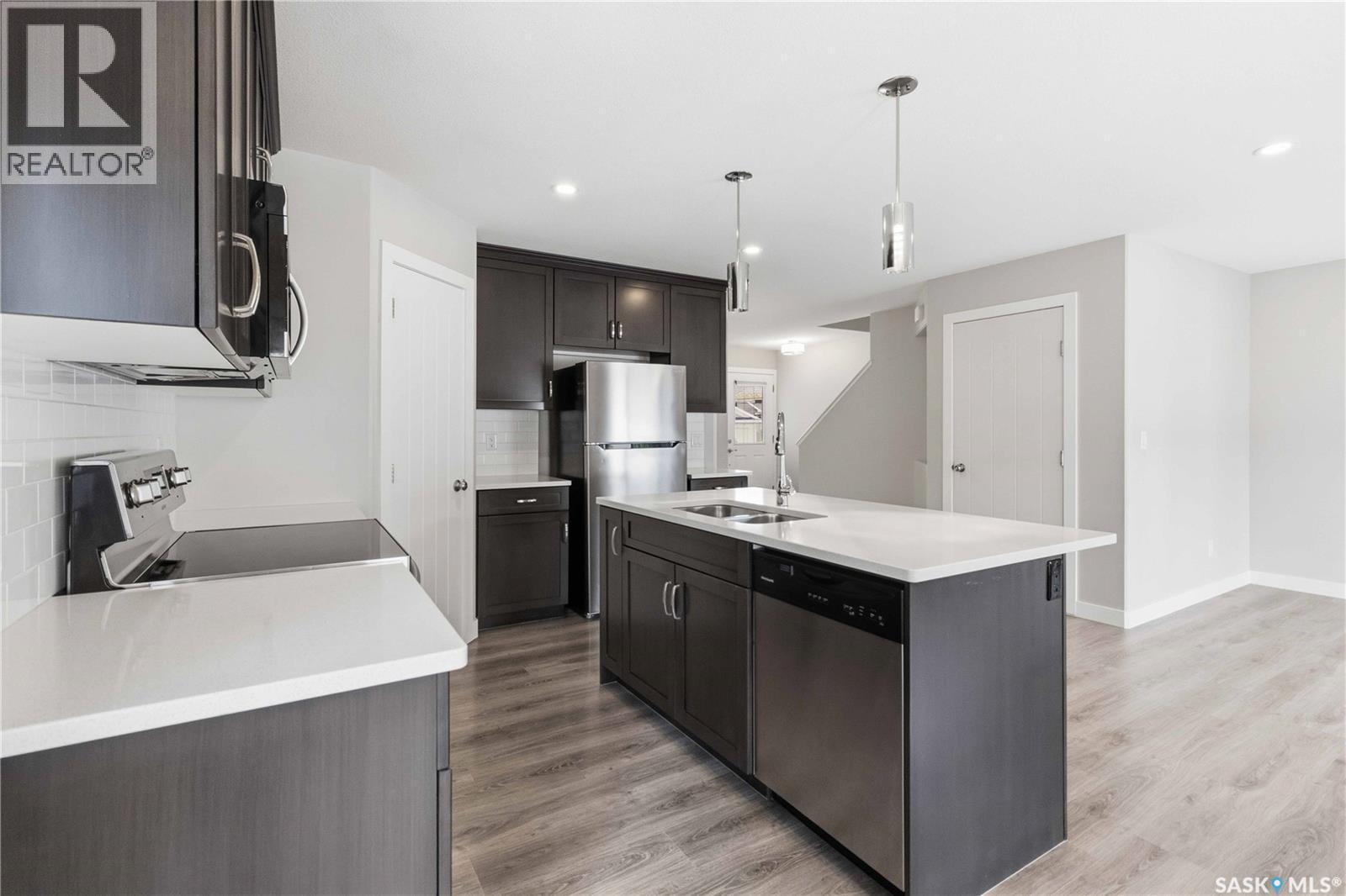 139 Dagnone Lane, Saskatoon, SK - Indoor Photo Showing Kitchen With Double Sink