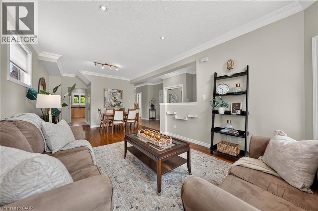 Open-concept living area featuring hardwood flooring, recessed lighting, and crown molding - 24 Knack Lane, Cambridge, ON - Indoor Photo Showing Living Room
