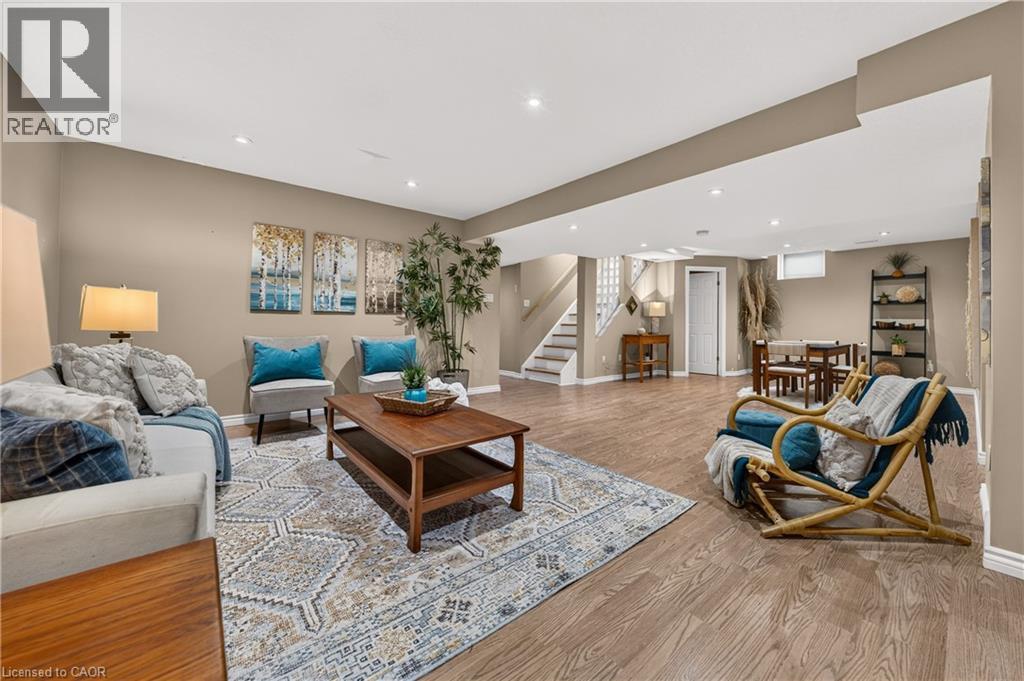 Spacious lower level featuring wood-finish flooring, recessed lighting, and a neutral color palette - 24 Knack Lane, Cambridge, ON - Indoor Photo Showing Living Room