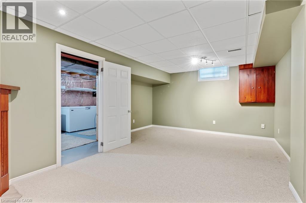 Carpeted room with recessed lighting and a drop ceiling - 129 Kovac Road, Cambridge, ON - Indoor Photo Showing Basement