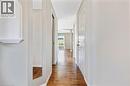 Hallway featuring wood-finish flooring, light grey painted walls, recessed lighting, and a decorative wall niche with a shelf - 129 Kovac Road, Cambridge, ON  - Indoor Photo Showing Other Room 