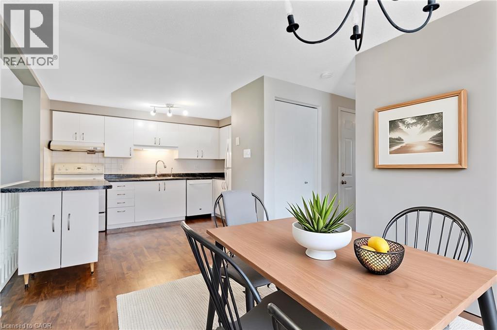 Open-concept kitchen and dining area featuring wood-finish flooring - 129 Kovac Road, Cambridge, ON - Indoor