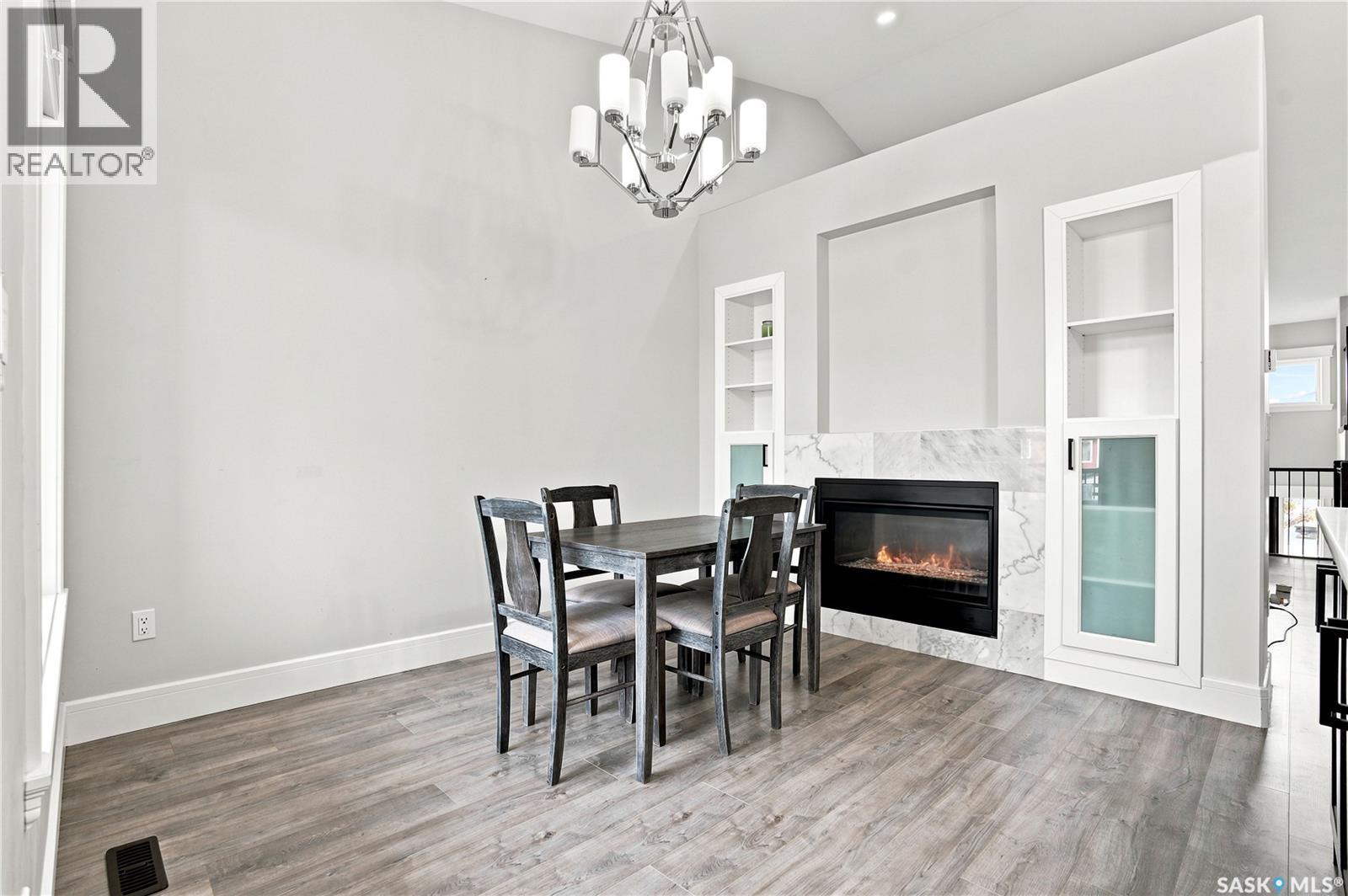 670 Fast Crescent, Saskatoon, SK - Indoor Photo Showing Dining Room With Fireplace