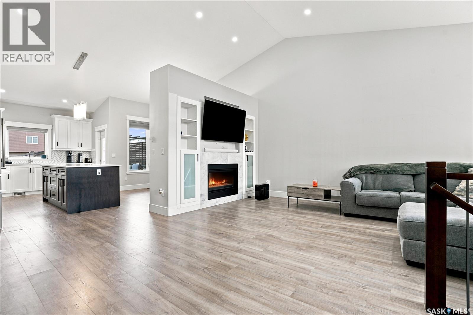 670 Fast Crescent, Saskatoon, SK - Indoor Photo Showing Other Room With Fireplace