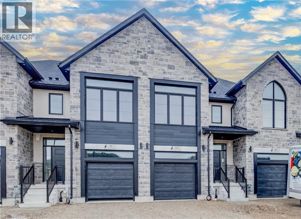 Stone facade townhomes featuring prominent gabled roofs and dark trim accents - 89 Rivergreen Crescent, Cambridge, ON - Outdoor With Facade