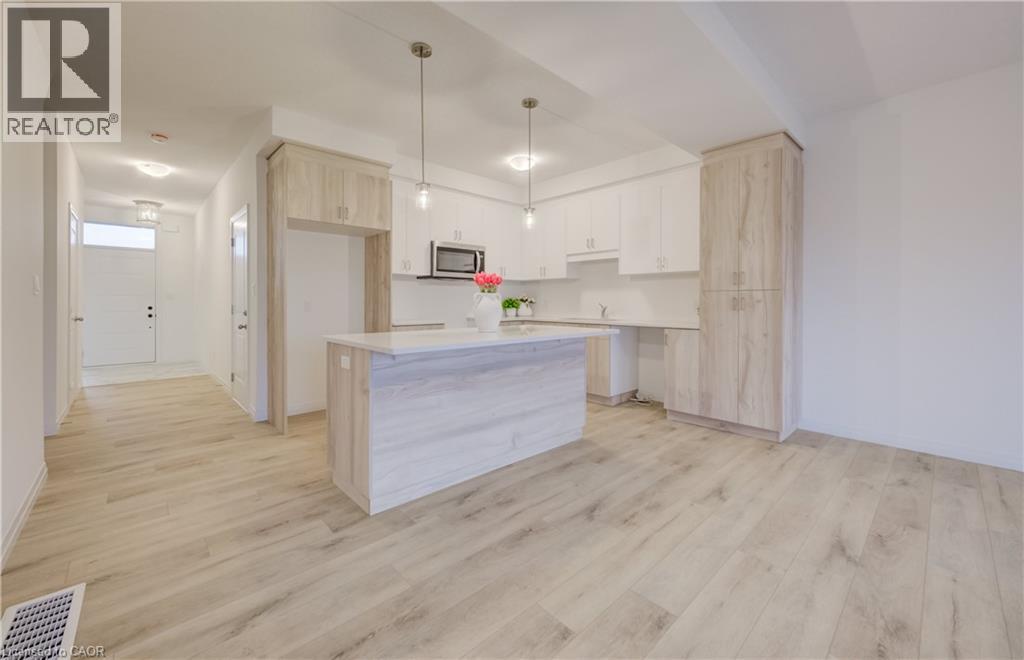 Open-concept kitchen and living area featuring wood-finish flooring - 89 Rivergreen Crescent, Cambridge, ON - Indoor Photo Showing Kitchen