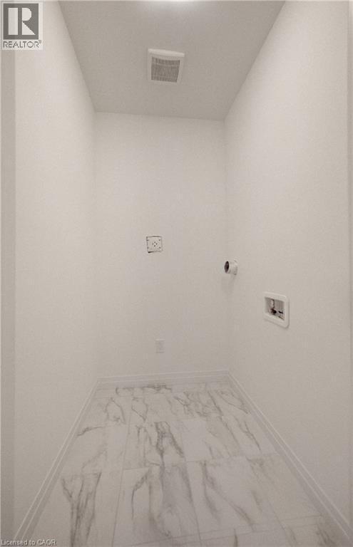 Dedicated utility space featuring white walls and marble-look tile flooring - 89 Rivergreen Crescent, Cambridge, ON - Indoor Photo Showing Other Room