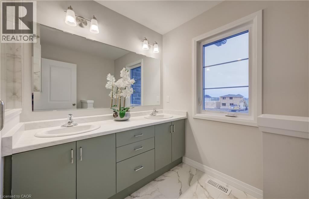 Dual vanity with undermount sinks and light gray cabinetry, complemented by a large wall-mounted mirror - 89 Rivergreen Crescent, Cambridge, ON - Indoor Photo Showing Bathroom