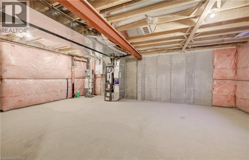 Unfinished basement offering substantial open space, concrete flooring, exposed ceiling joists, and visible insulation along perimeter walls - 89 Rivergreen Crescent, Cambridge, ON - Indoor Photo Showing Basement