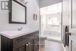Updated bathroom with walk-through shower to tub. - 