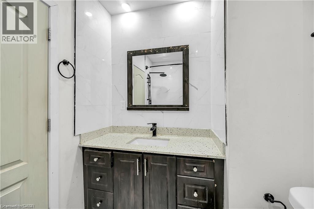 Contemporary vanity with a light speckled countertop and undermount sink - 334 Cannon Street E, Hamilton, ON - Indoor Photo Showing Bathroom
