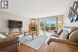 Gas fireplace, hardwood flooring and walkout to deck. -