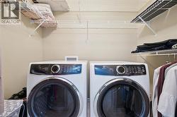 Main floor laundry (tucked neatly away in the primary bedroom). -