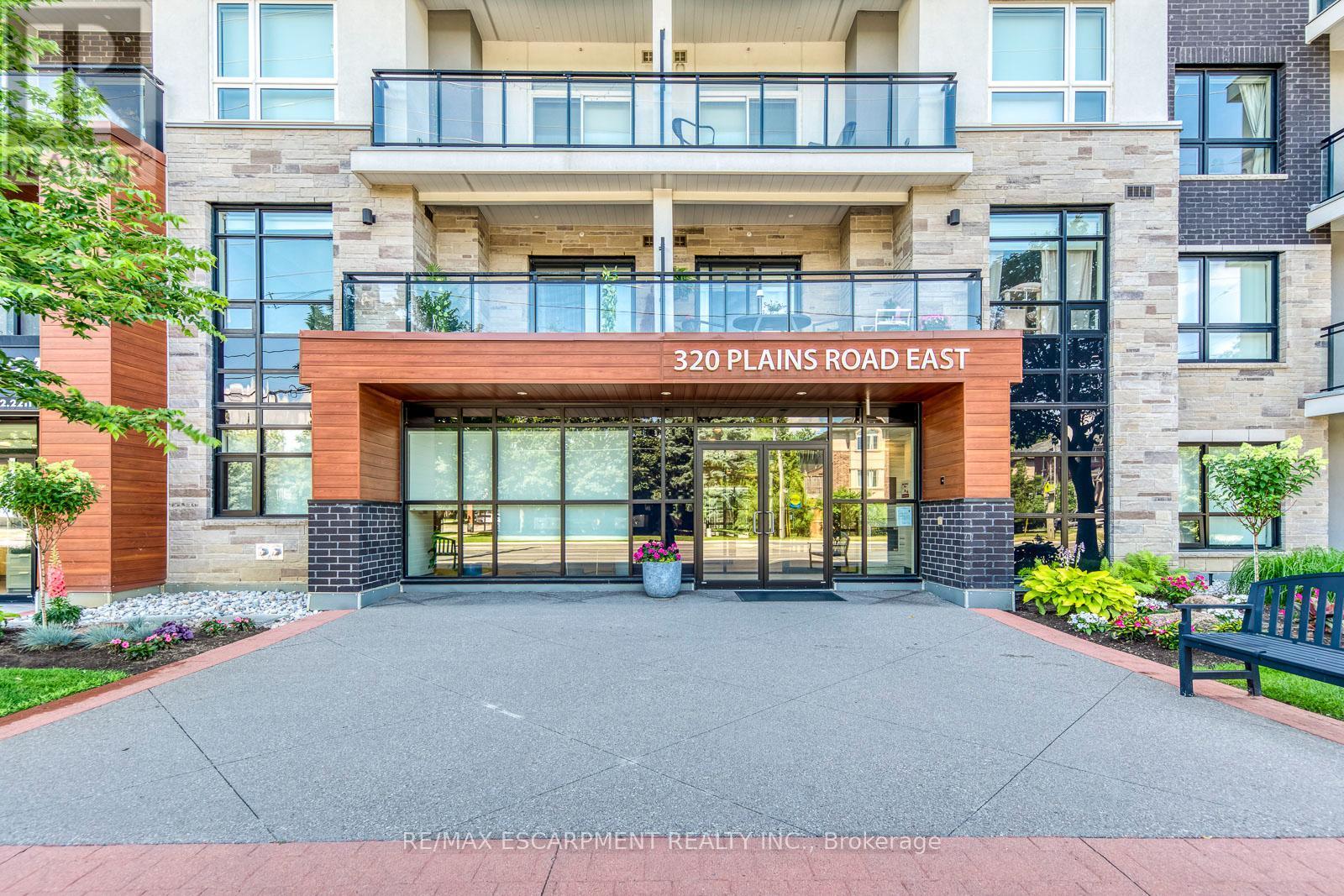 303 - 320 Plains Road E, Burlington, ON - Outdoor With Balcony With Facade