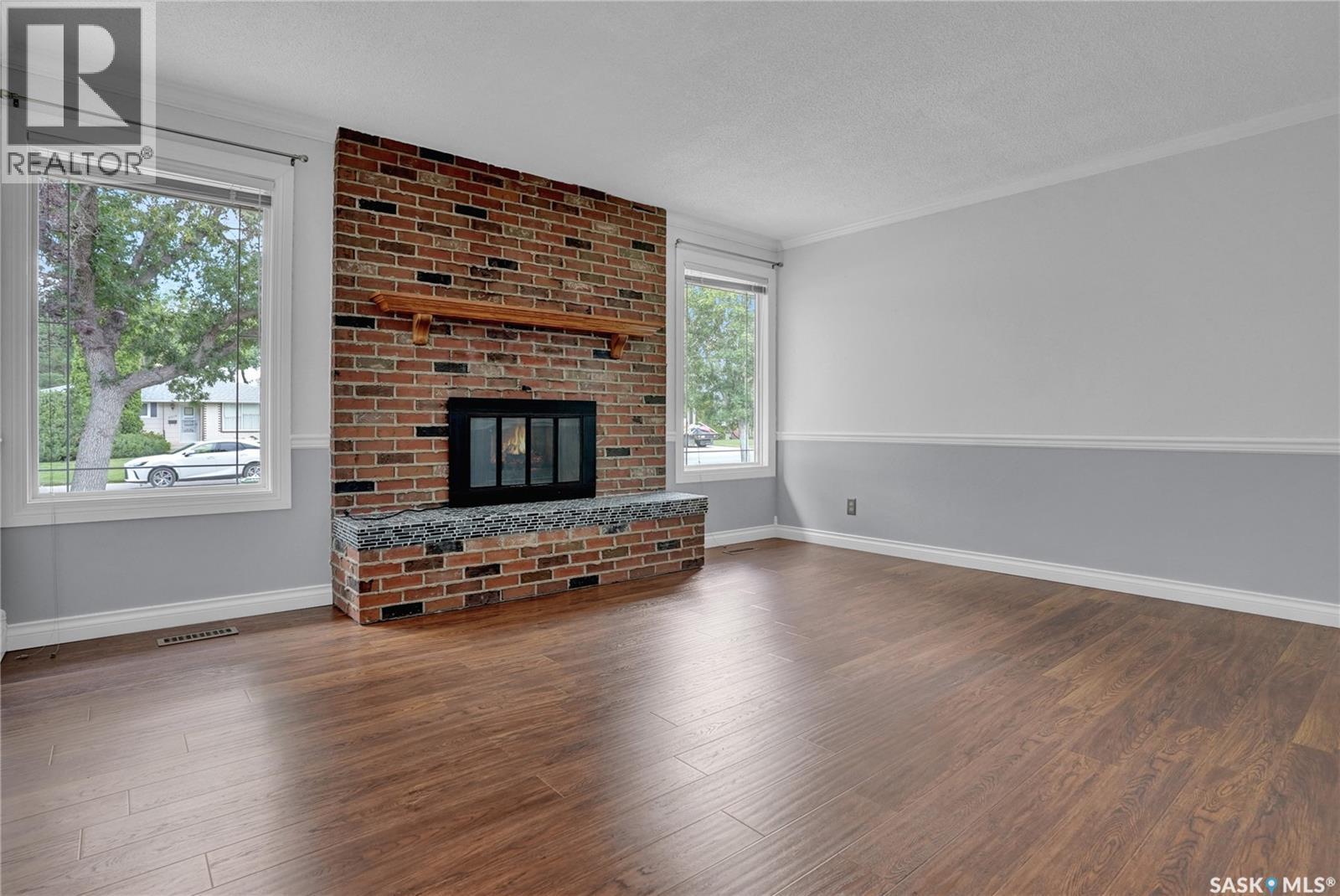 6015 7Th Avenue N, Regina, SK - Indoor Photo Showing Living Room With Fireplace