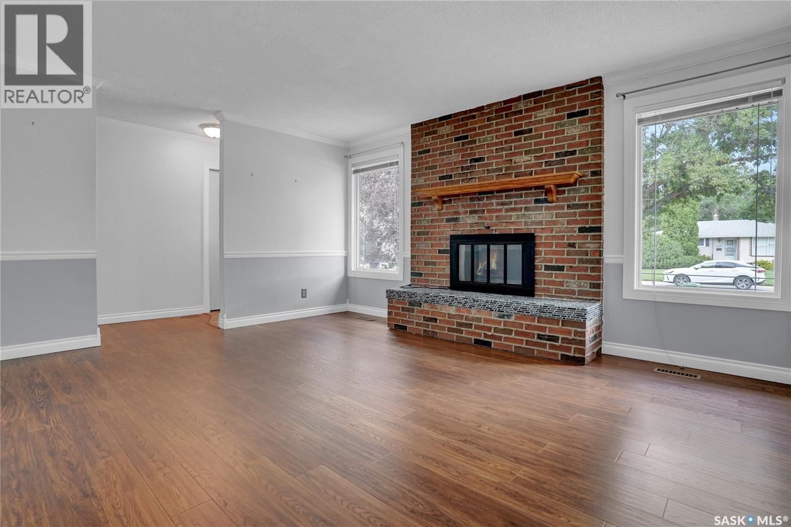 6015 7Th Avenue N, Regina, SK - Indoor Photo Showing Living Room With Fireplace