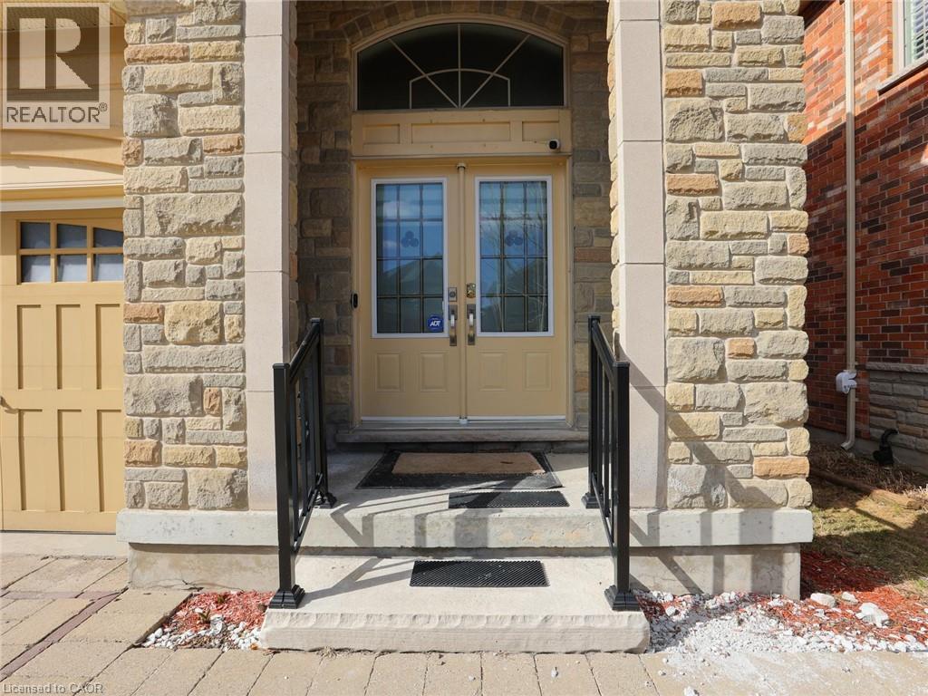 Stone veneer facade with prominent columns framing the main entry - 584 Pinery Trail, Waterloo, ON - Outdoor