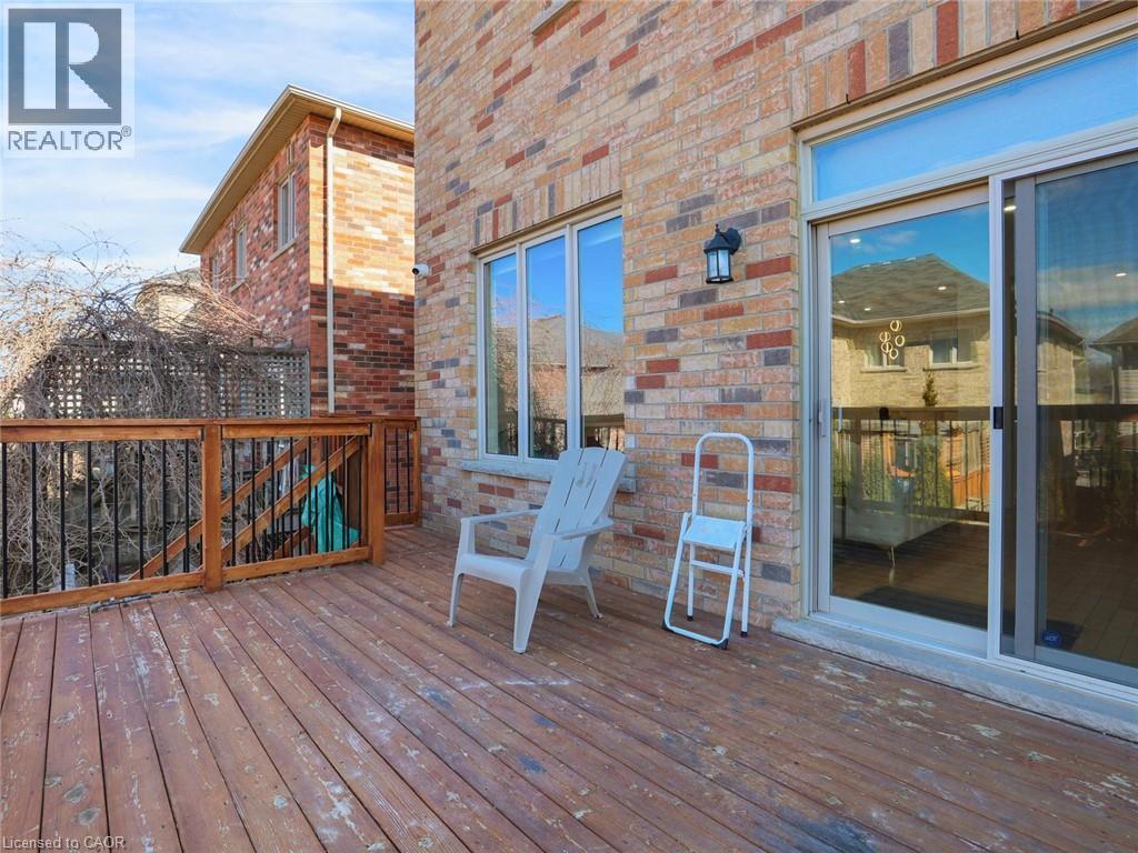 Spacious wood-finish deck with a wood and metal railing - 584 Pinery Trail, Waterloo, ON - Outdoor With Deck Patio Veranda With Exterior