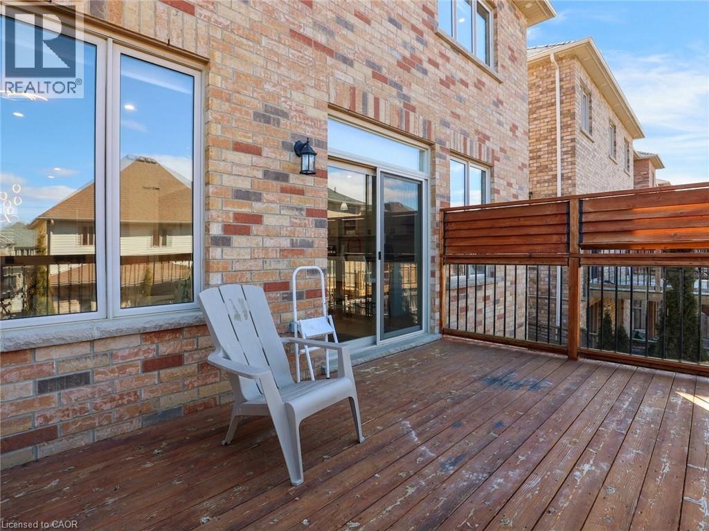 Expansive outdoor deck featuring wood-finish flooring and a privacy fence - 584 Pinery Trail, Waterloo, ON - Outdoor With Deck Patio Veranda With Exterior