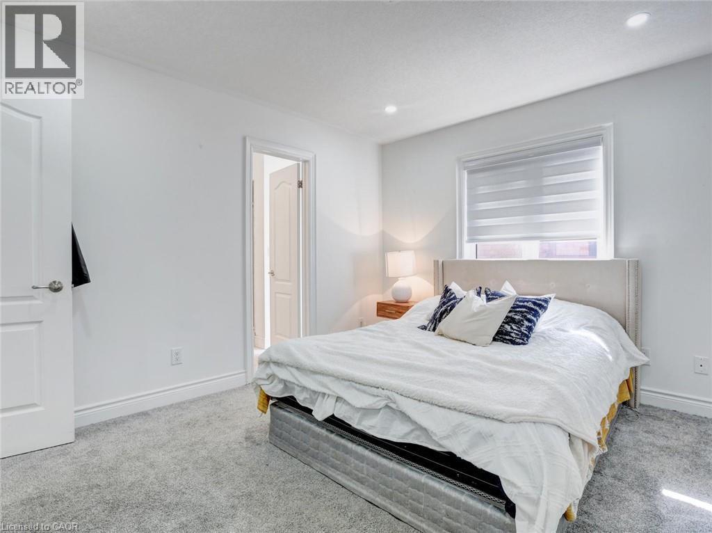 Bedroom featuring plush gray carpet flooring, white walls, and bright white trim - 584 Pinery Trail, Waterloo, ON - Indoor Photo Showing Bedroom