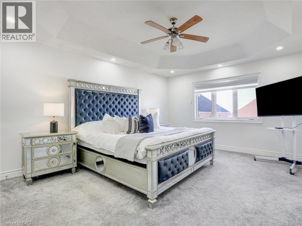 Recessed lighting illuminates a trey ceiling - 584 Pinery Trail, Waterloo, ON - Indoor Photo Showing Bedroom